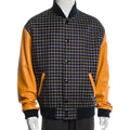 Front view of Access Hollywood Mart J. Blige checkered varsity jacket with yellow and black grid design and orange leather sleeves.