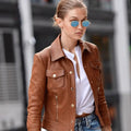 Side profile of NYC Gigi Hadid brown leather moto jacket showcasing buttoned cuffs