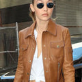 Close-up of buttoned closure on NYC Gigi Hadid brown leather moto jacket